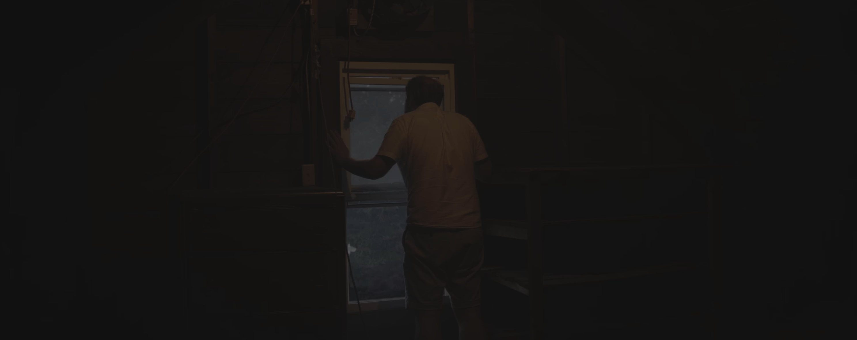 Figure standing in a dim interior